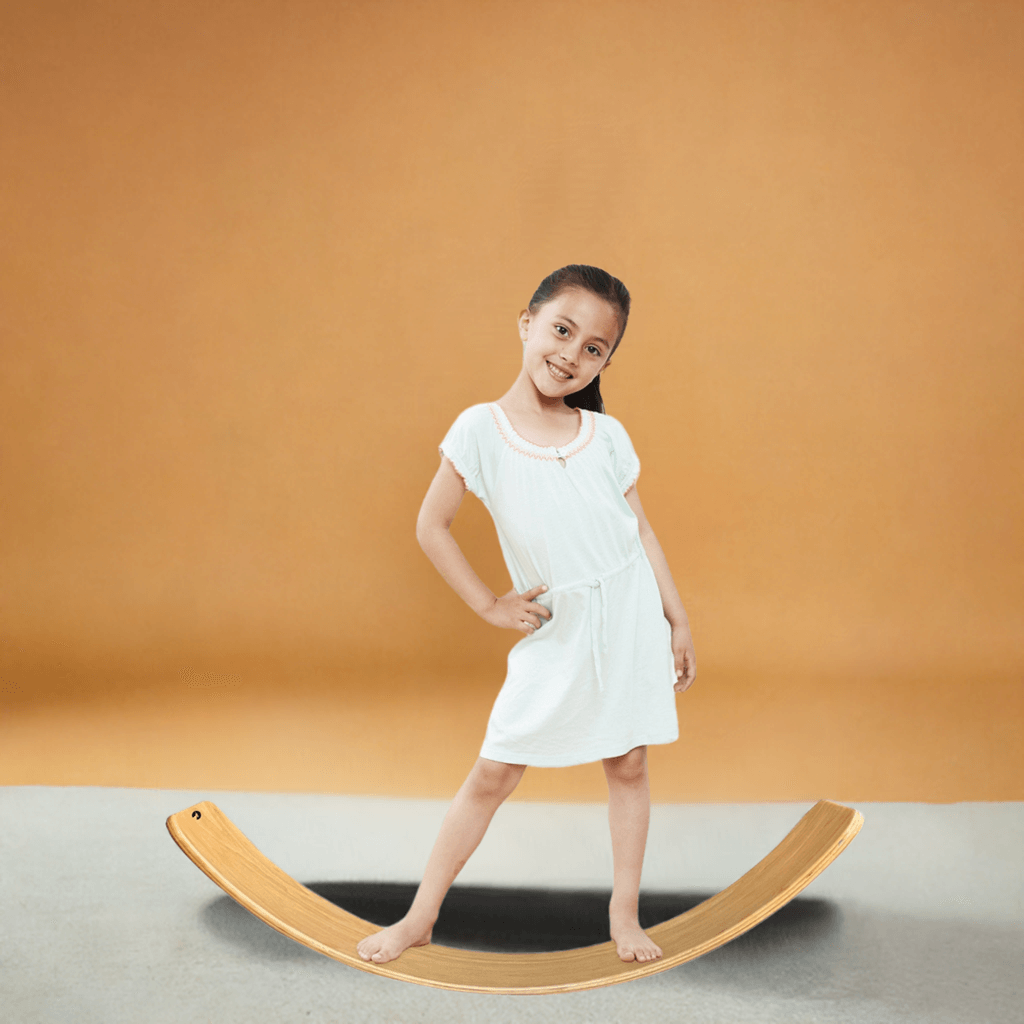 Child balancing on BILLY Wooden Wobble Board ideal for yoga and exercise, designed for kids and adults, eco-friendly natural wood.